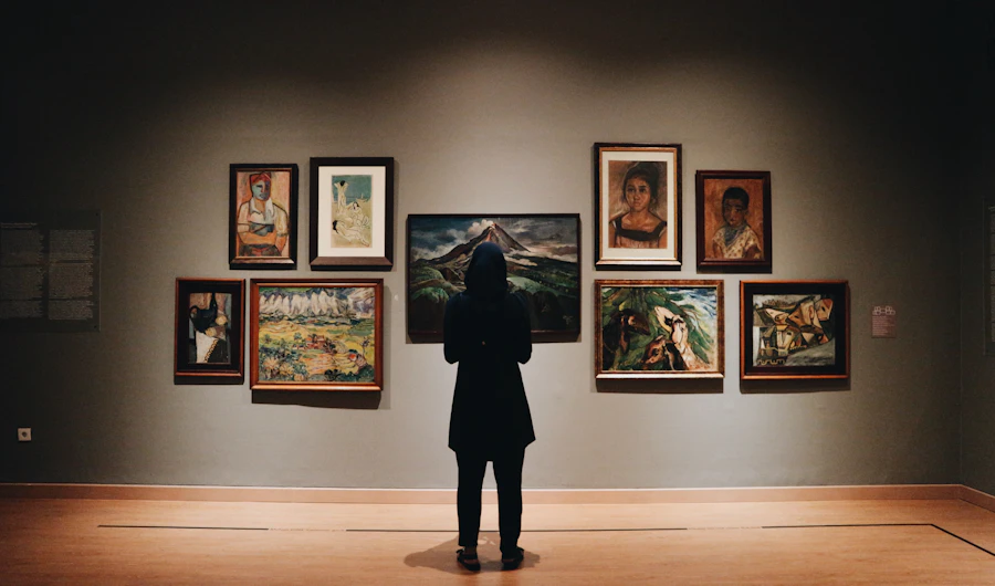 Visitor looking at paintings in an art gallery