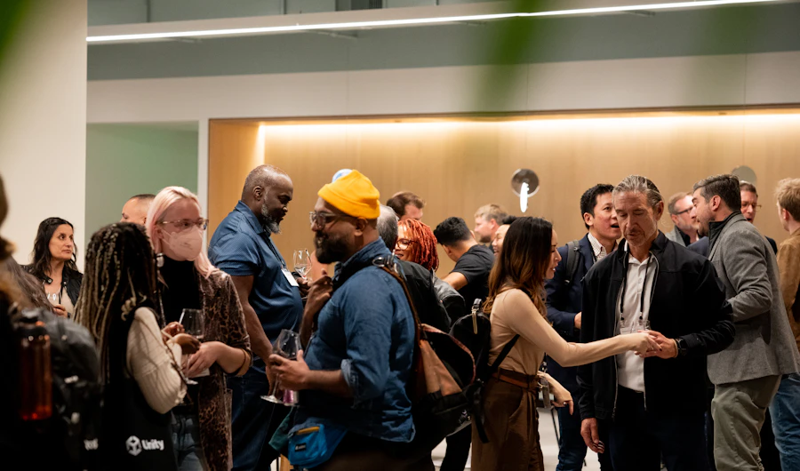 People mingling and talking at an evening networking event