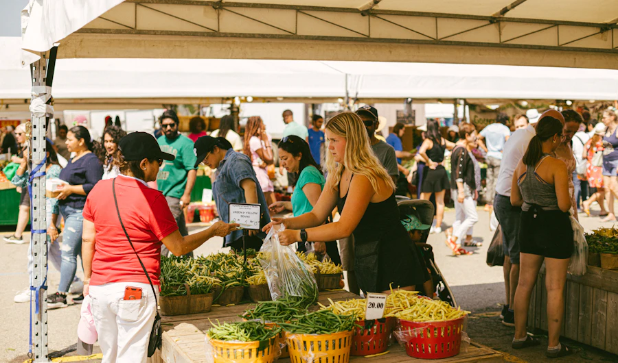Shoppers at an outdoor fruit and vegetable market