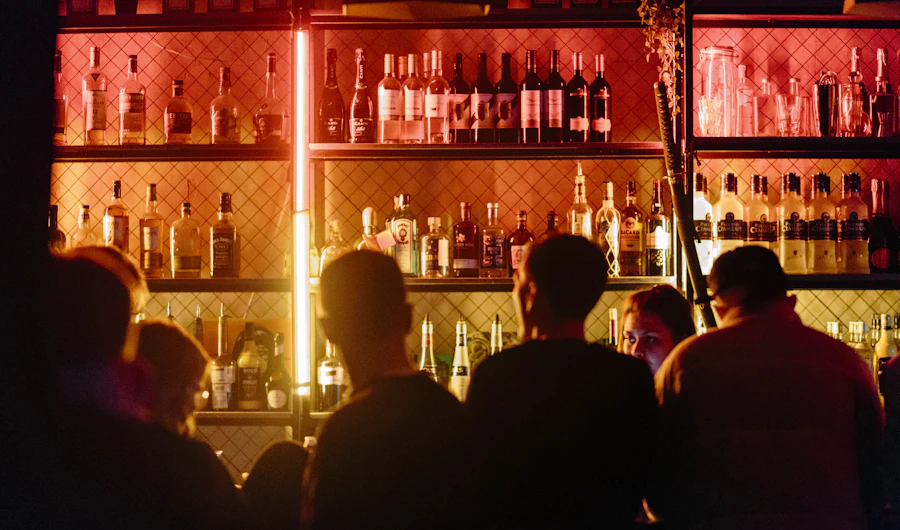 People at a bar lit in red at night